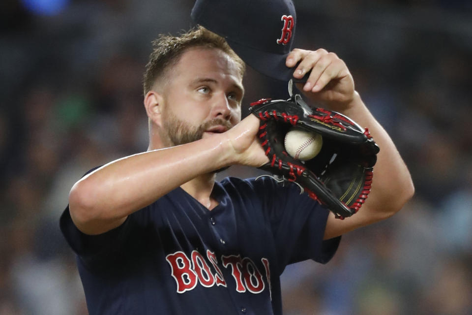 Boston Red Sox starting pitcher Brian Johnson removes his cap after allowing a two-run double to New York Yankees' Cameron Maybin during the third inning in the second baseball game of a doubleheader Saturday, Aug. 3, 2019, in New York. (AP Photo/Kathy Willens)