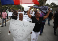 <p>Jocelyne Pierre and Yanick Gorneo (L-R) join with others to mark the 8th anniversary of the massive earthquake in Haiti and to condemn President Donald Trump’s reported statement about immigrants from Haiti, Africa and El Salvador on Jan. 12, 2018 in Miami, Fla. (Photo: Joe Raedle/Getty Images) </p>