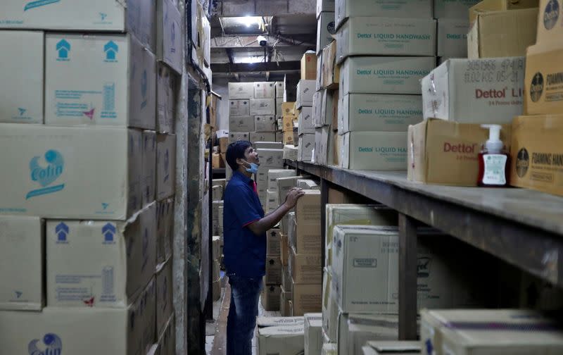 A worker inspects boxes of Reckitt's Dettol handwash at a distributor’s warehouse before loading them onto a truck for delivery to retailers in Mumbai