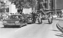 Seen through the limousine’s windshield as it proceeds along Elm Street past the Texas School Book Depository, President John F. Kennedy appears to raise his hand toward his head within seconds of being fatally shot in Dallas, Nov 22, 1963. Mrs. Jacqueline Kennedy holds the President’s forearm in an effort to aid him. Gov. John Connally of Texas, who was in the front seat, was also shot. (Photo: Jim Altgens/AP)