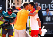 Tennis - ATP World Tour Masters 1000 - Italian Open - Foro Italico, Rome, Italy - May 19, 2018 Spain's Rafael Nadal hugs Serbia's Novak Djokovic after winning their semi final match REUTERS/Tony Gentile