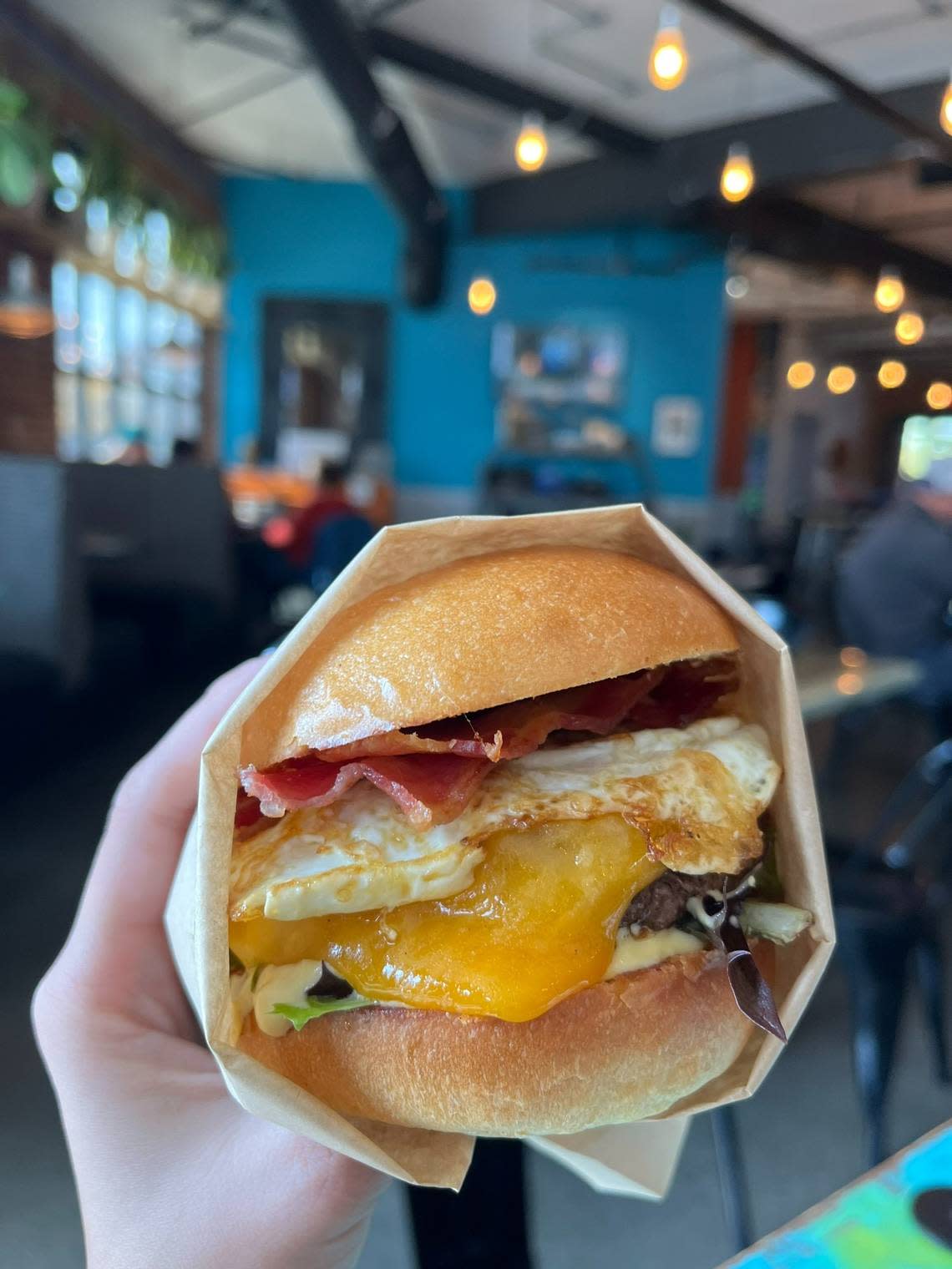 The burger at DV8 Kitchen on Midland and Third is a Black Angus patty topped with a fried egg, cheese, ham and more on a brioche bun or biscuit made in house.