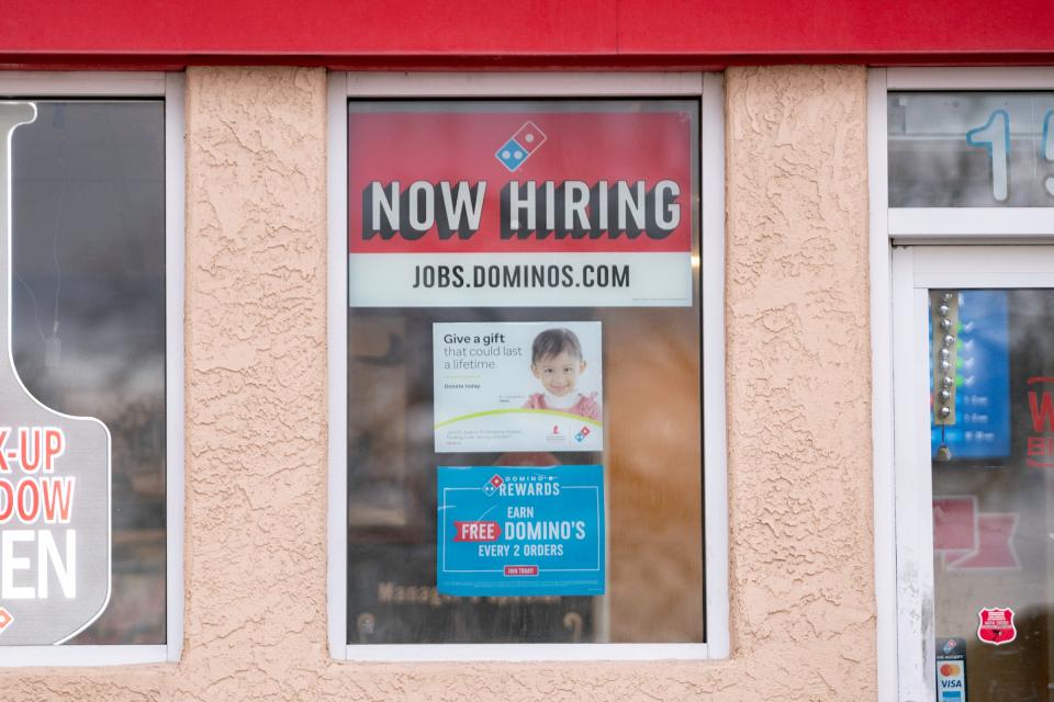 A now hiring sign hangs in the window of Pueblo's south side Dominos on Thursday, March 7, 2024.