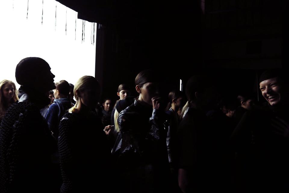 Models gather backstage for a rehearsal before the Alexander Wang Fall 2014 collection show during Fashion Week in New York, Saturday, Feb. 8, 2014. (AP Photo/Jason DeCrow)