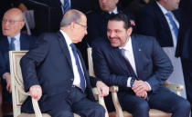 Saad al-Hariri, who announced his resignation as Lebanon's prime minister from Saudi Arabia reacts as he talks with Lebanese President Michel Aoun while attending a military parade to celebrate the 74th anniversary of Lebanon's independence in downtown Beirut, Lebanon November 22, 2017. REUTERS/Mohamed Azakir