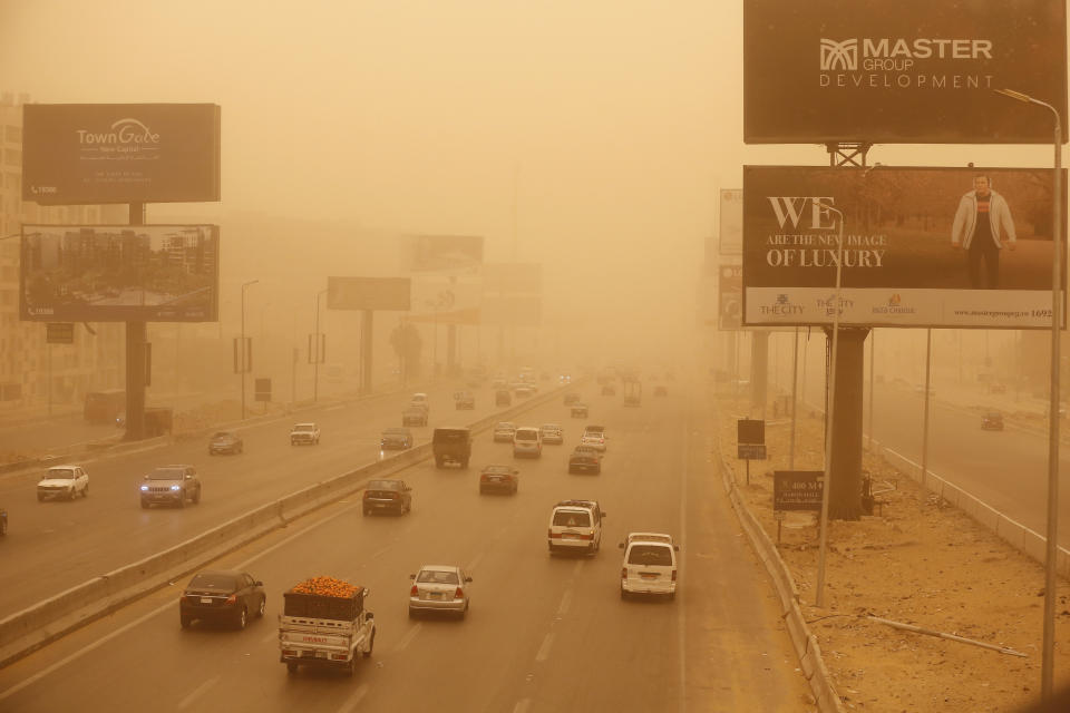 Vehicles drive during a sandstorm in Cairo, Egypt, Wednesday, Jan. 16, 2019. A harsh weather front brought sandstorms, hail and rain to parts of the Middle East, with visibility down in the Egyptian capital as an orange cloud of dust blocked out the sky. (AP Photo/Amr Nabil)