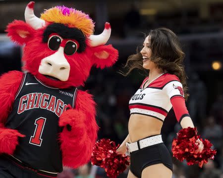 Dec 8, 2018; Chicago, IL, USA; A Chicago Bulls cheerleader is seen with Benny the Bull during the second half against the Boston Celtics at United Center. Patrick Gorski-USA TODAY Sports