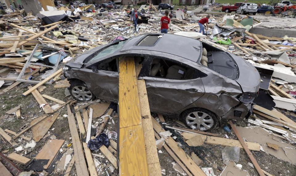 Volunteers continue to salvage items for residents who lost their homes to Sunday's tornado, Tuesday, April 29, 2014, in Vilonia, Ark. A dangerous storm system that spawned a chain of deadly tornadoes killed dozens from the Midwest to the Deep South. (AP Photo/Eric Gay)