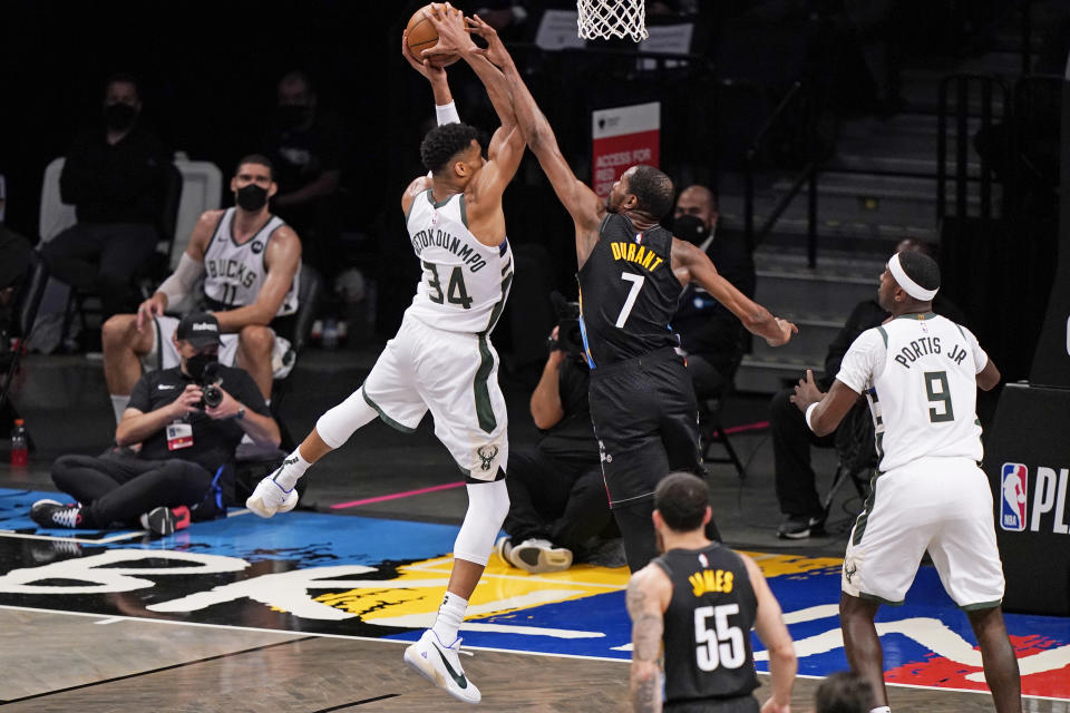 Brooklyn Nets forward Kevin Durant (7) tries to block a shot by Milwaukee Bucks forward Giannis Antetokounmpo (34) as Bucks center Bobby Portis (9) looks on during the third quarter of Game 2 of an NBA basketball second-round playoff series, Monday, June 7, 2021, in New York. (AP Photo/Kathy Willens)