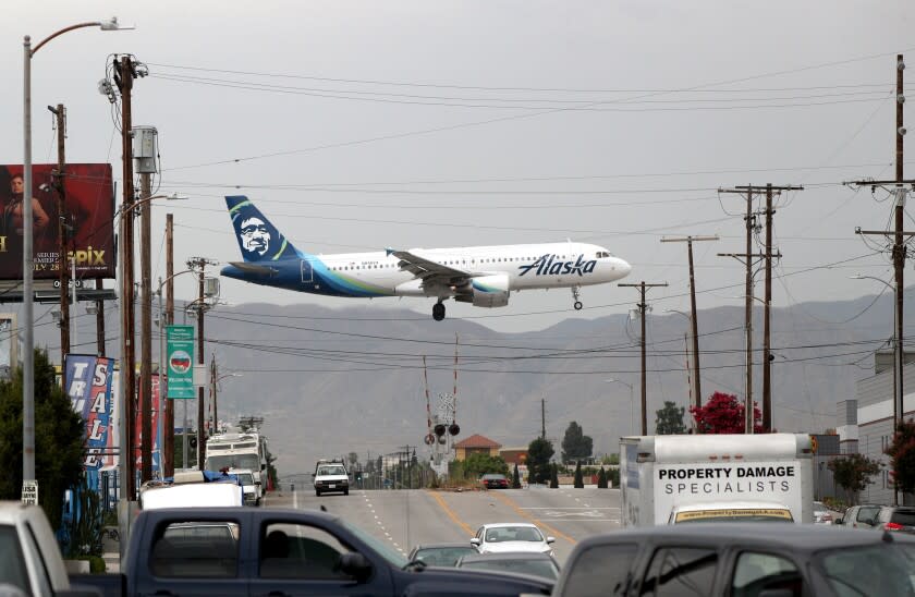 An Alaska Airlines plane crosses Vineland Ave., in North Hollywood, at it lands at the Hollywood Burbank Airport, on Thursday, July 25, 2019.