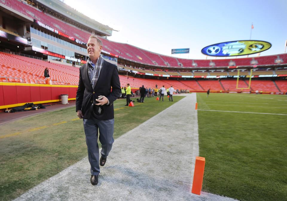 BYU athletic director Tom Holmoe walks on the field at Arrowhead Stadium prior to a game with Missouri in Kansas City.