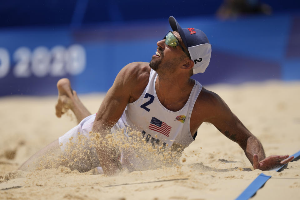 Nicholas Lucena, of the United States, hits the sand ad he competes during a men's beach volleyball match against Argentina at the 2020 Summer Olympics, Thursday, July 29, 2021, in Tokyo, Japan. (AP Photo/Petros Giannakouris)