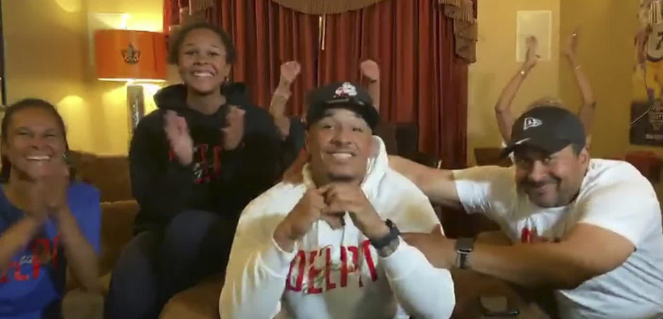 In this still image from video provided by the NFL, Grant Delpit, center, gets congratulated as he's selected by the Cleveland Browns during the second round of the NFL football draft, Friday, April 24, 2020. (NFL via AP)