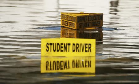 Driver education vehicles are seen submerged in floodwaters following Hurricane Matthew in Lumberton, North Carolina, U.S., October 10, 2016. REUTERS/Carlo Allegri