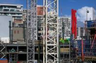 Recently completed residential apartment blocks are seen behind a construction site in central Auckland, New Zealand, June 25, 2017. REUTERS/David Gray