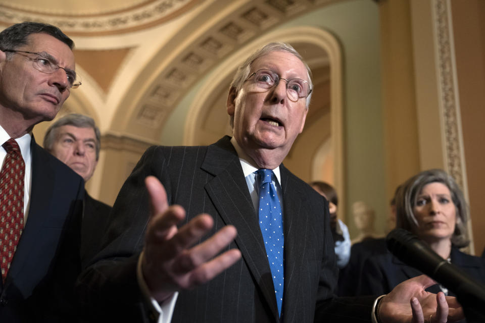 Senate Majority Leader Mitch McConnell, R-Ky., joined from left by Sen. John Barrasso, R-Wyo., Sen. Roy Blunt, R-Mo., and Sen. Joni Ernst, R-Iowa, fields questions from reporters about an impeachment trial in the Senate after Speaker of the House Nancy Pelosi, D-Calif., announced House Democrats are pushing ahead with formal charges against President Donald Trump saying he has put U.S. elections and national security at risk, at the Capitol in Washington, Tuesday, Dec. 10, 2019. (AP Photo/J. Scott Applewhite)