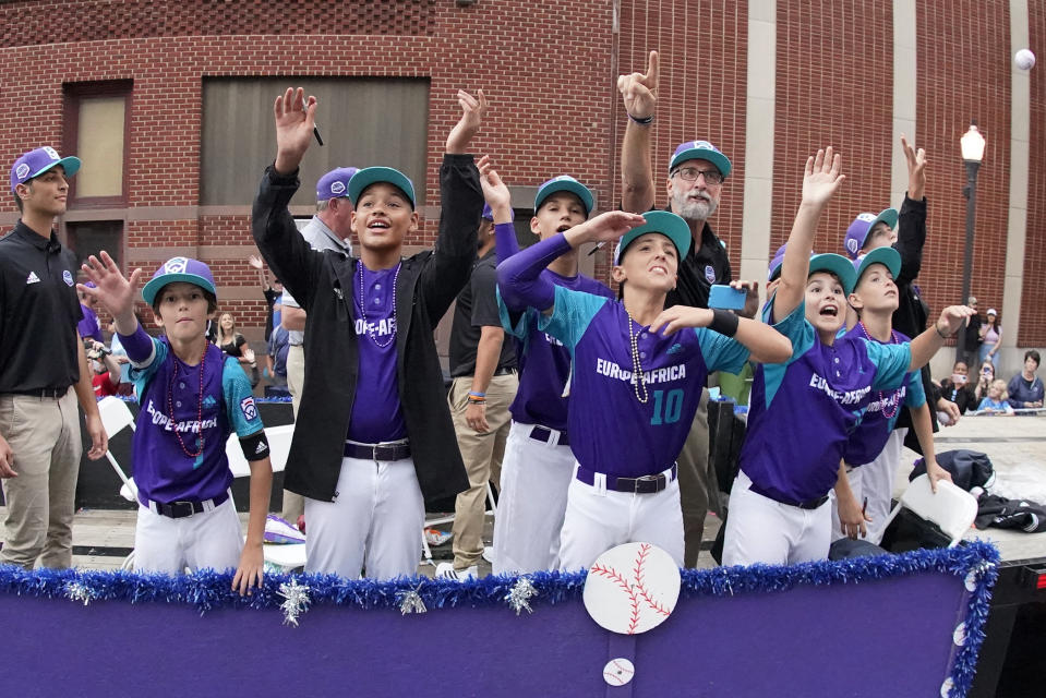 The Europe-Africa Region champion Little League team from Bologna, Italy, rides in the Little League Grand Slam Parade in downtown Williamsport, Pa., on Monday, Aug. 15, 2022. The Little League World Series baseball tournament, featuring 20 teams from around the world, starts Wednesday in South Williamsport, Pa.. (AP Photo/Gene J. Puskar)