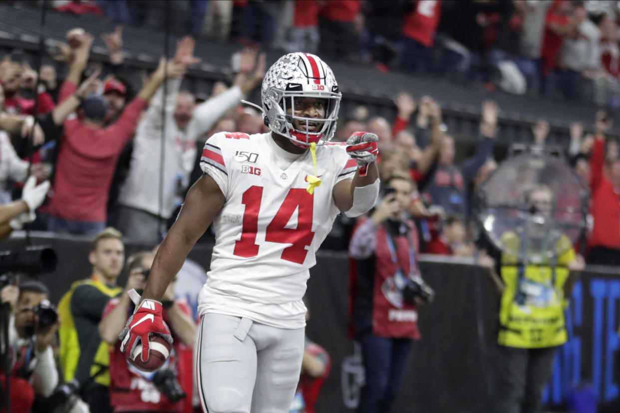 Ohio State wide receiver K.J. Hill (14) celebrates after making a touchdown catch during the second half of the team's Big Ten championship NCAA college football game against Wisconsin, Saturday, Dec. 7, 2019, in Indianapolis. (AP Photo/Michael Conroy)