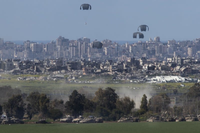 A U.S. Air Force C-130 drops humanitarian aid by parachute over the northern Gaza Strip as seen from inside southern Israel on March 10, 2024. An attack on a food distribution point in Gaza City Thursday killed 21 and wounded at least 150 others. Photo by Jim Hollander/UPI