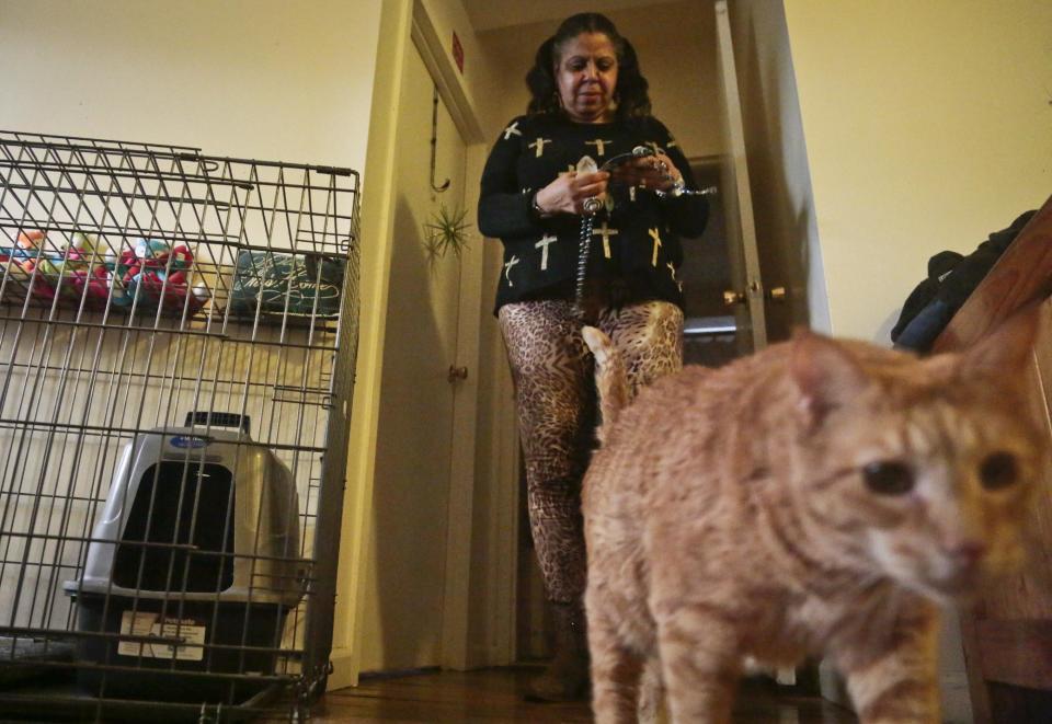 Pamela Isaac and one of her three cats, Lucy, inside their apartment at a shelter for victims of domestic violence, Tuesday March 18, 2014 in New York. The shelter is the city’s first pet-friendly domestic violence shelter, one in a fast-growing number of similar sanctuaries around the country that reflect growing awareness that animals can be both victims of family violence and key factors in their owners’ willingness to flee. (AP Photo/Bebeto Matthews)
