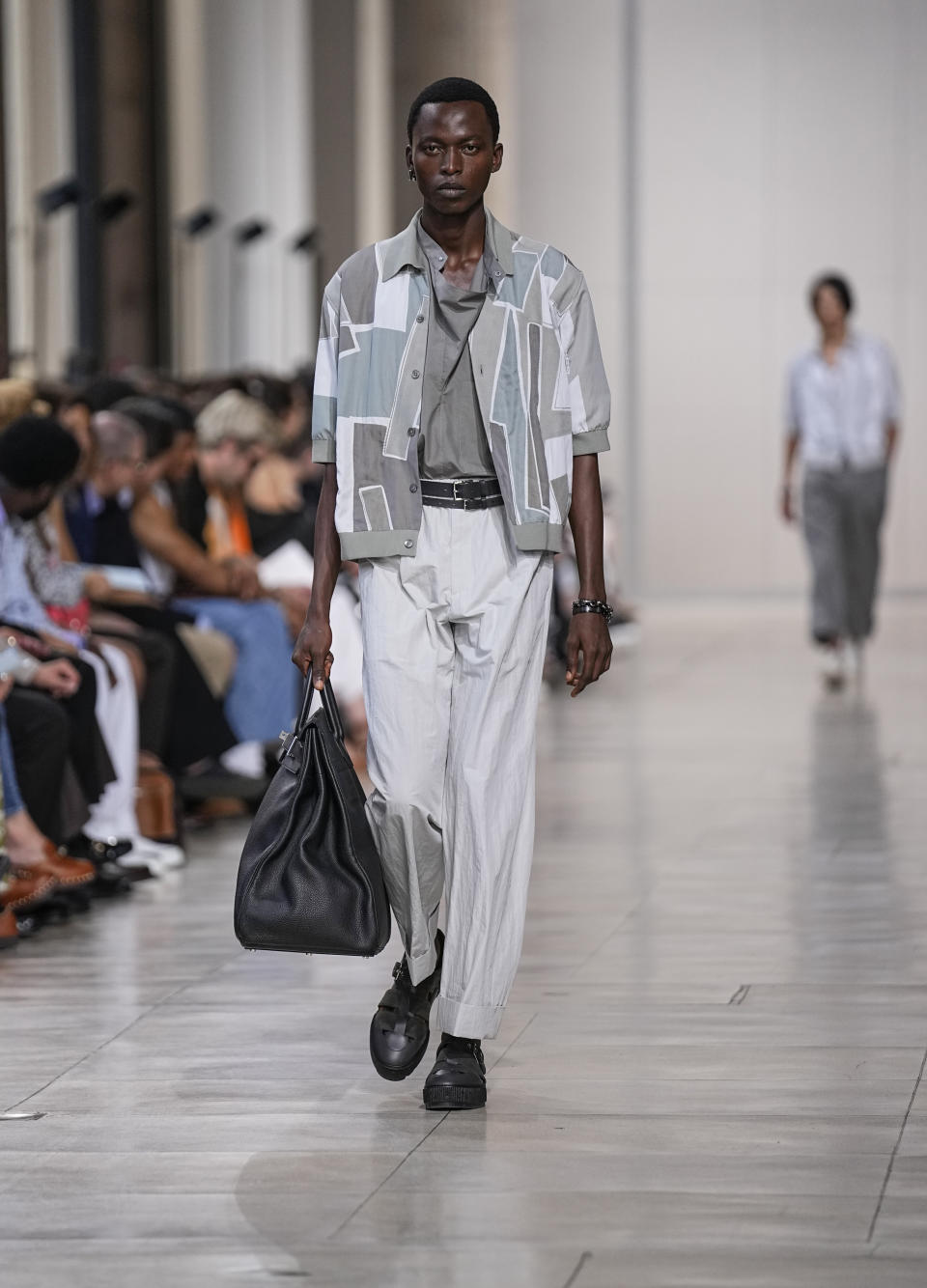 A model wears a creation for the Hermes Menswear Spring/Summer 2024 fashion collection presented in Paris, Saturday, June 24, 2023. (AP Photo/Michel Euler)