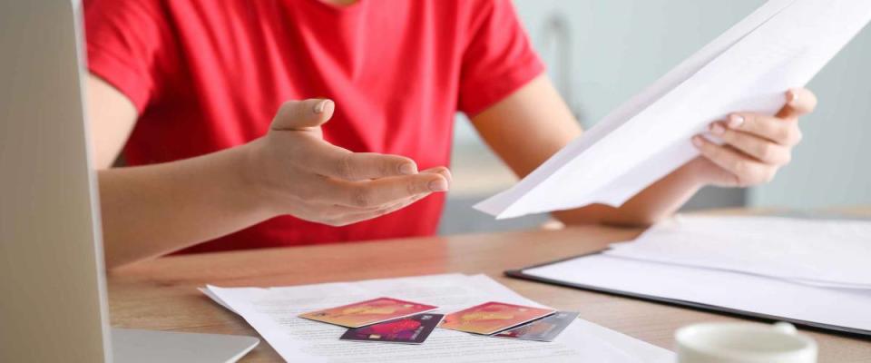 Worried young woman in debt at home