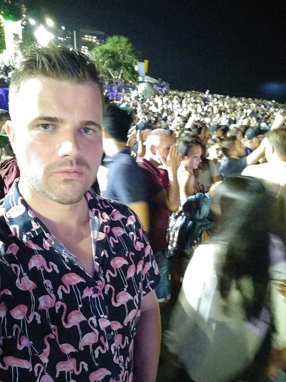 Gable Tostee takes a selfie among a crowd of people at night time. The photo was posted on New Year's Day.