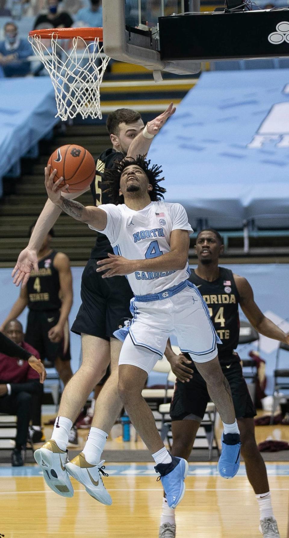 North Carolina’s R.J. Davis (4) breaks to the basket past Florida State’s Balsa Koprivica (5) during the first half on Saturday, February 27, 2021 in Chapel Hill, N.C.