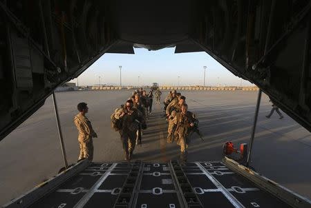 U.S. Marines prepare to board a plane at the end of operations for U.S. Marines and British combat troops in Helmand October 26, 2014. REUTERS/Omar Sobhani