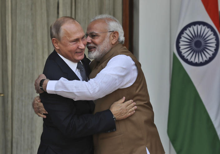 FILE - In this Oct. 5, 2018 file photo, Indian Prime Minister Narendra Modi, right, hugs Russian President Vladimir Putin before their meeting in New Delhi, India. Modi won a second term in office in May, 2019, by presenting a muscular image to voters by ordering an air strike inside Pakistan in response to a suicide attack on Indian paramilitary forces in troubled Kashmir ahead of national elections. But he will now be required to navigate deftly in a climate of deteriorating trade relations between the United States and China and its fallout on India and rising tensions between the United States and Iran. Russia's improving ties with Pakistan and China also pose a challenge to Modi to use his influence with President Vladimir Putin to avoid any setback to the relationship between the two countries who have been friends since the Cold War era. (AP Photo/Manish Swarup, File)