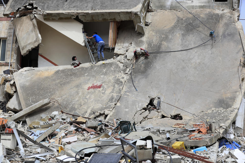 Lebanese villagers check their house which was destroyed by an Israeli airstrike, in Kfar Kila, a Lebanese border village with Israel, south Lebanon, Thursday, April 18, 2024. Hezbollah militants and Israeli forces have been exchanging fire since a day after the Israel-Hamas war began on Oct. 7. (AP Photo/Mohammed Zaatari)