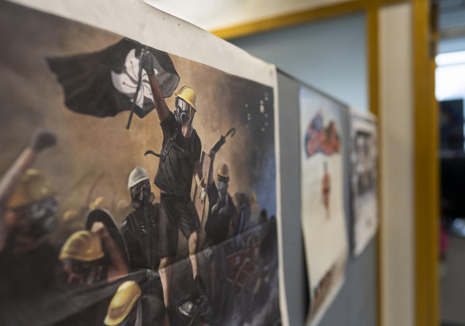 An Apple Daily poster showing a printing of the protesters is displayed at the news room of Apple Daily Monday, April 26, 2021 in Hong Kong. The Apple Daily editors and executives were detained Thursday, June 17, under a national security law that took effect last year. (AP Photo/Vincent Yu)