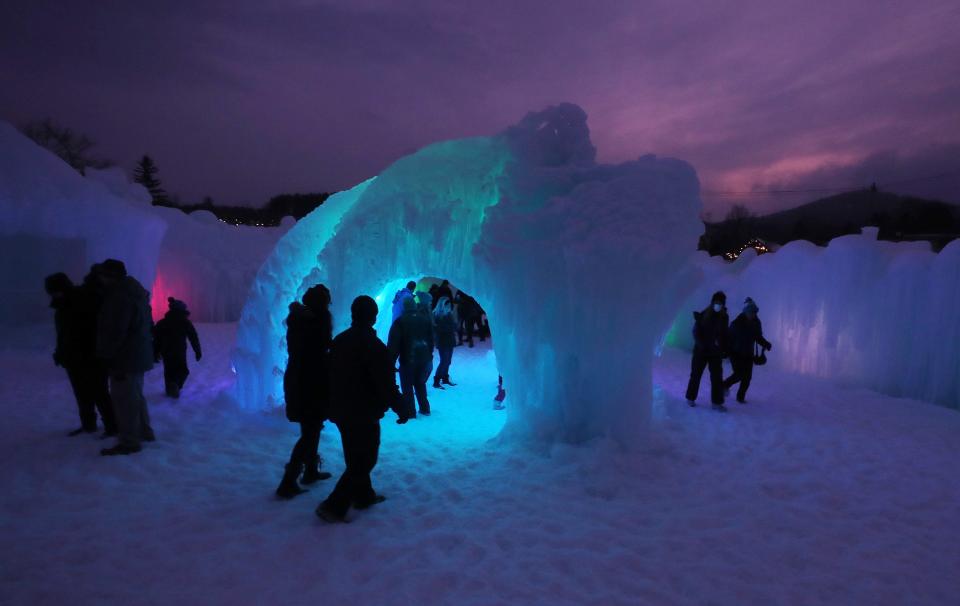 Visitors enjoy the ice and the lights on opening day of the Lake George Ice Castles in Charles Wood Park in the village of Lake George Jan. 23, 2022. The castles include LED-lit sculptures, frozen thrones, ice-carved tunnels, caverns, slides, and fountains. The Ice Castles, which were all built by hand, will remain open through late February or early March, depending on the weather.