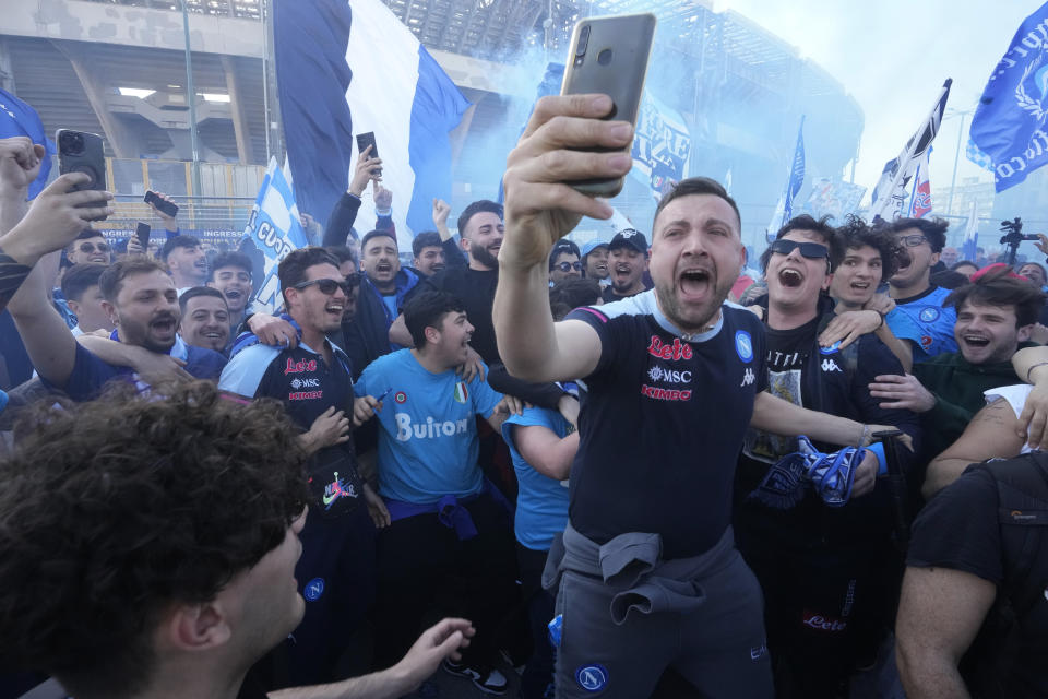 Napoli fans cheer in front of the Diego Armando Maradona stadium, in Naples, Italy, Thursday, May 4, 2023. (AP Photo/Andrew Medichini)