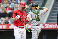 Los Angeles Angels center fielder Mike Trout, left, checks his bat after striking out, next to Oakland Athletics catcher Sean Murphy during the first inning of a baseball game in Anaheim, Calif., Saturday, May 21, 2022. (AP Photo/Alex Gallardo)