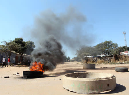 A tyre burns on a street in Mufakose in Harare, Zimbabwe, July 6, 2016. REUTERS/Philimon Bulawayo