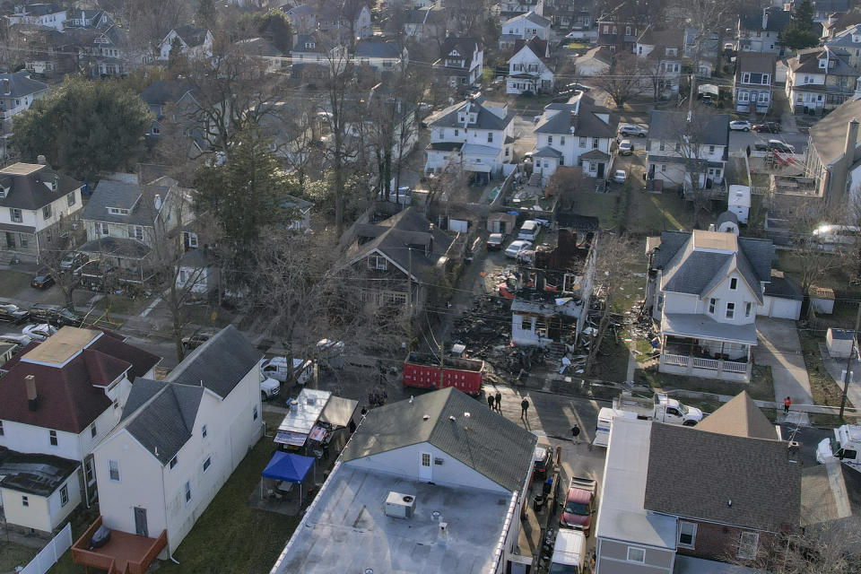 Investigators work at the scene where two police officers were injured while responding to reported standoff in East Lansdowne, Pa., Thursday, Feb. 8, 2024. (Heather Khalifa/The Philadelphia Inquirer via AP)