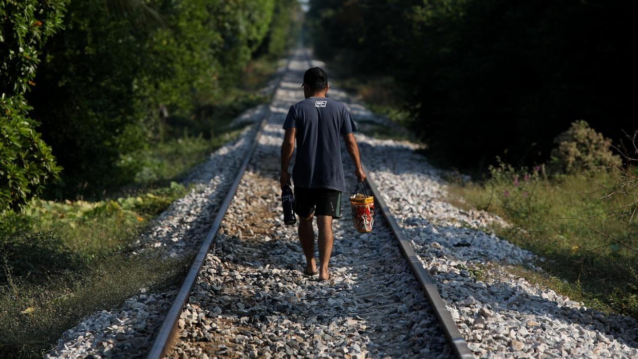  A man walks along the train track that is part of the Interoceanic Corridor of the Isthmus of Tehuantepec. 