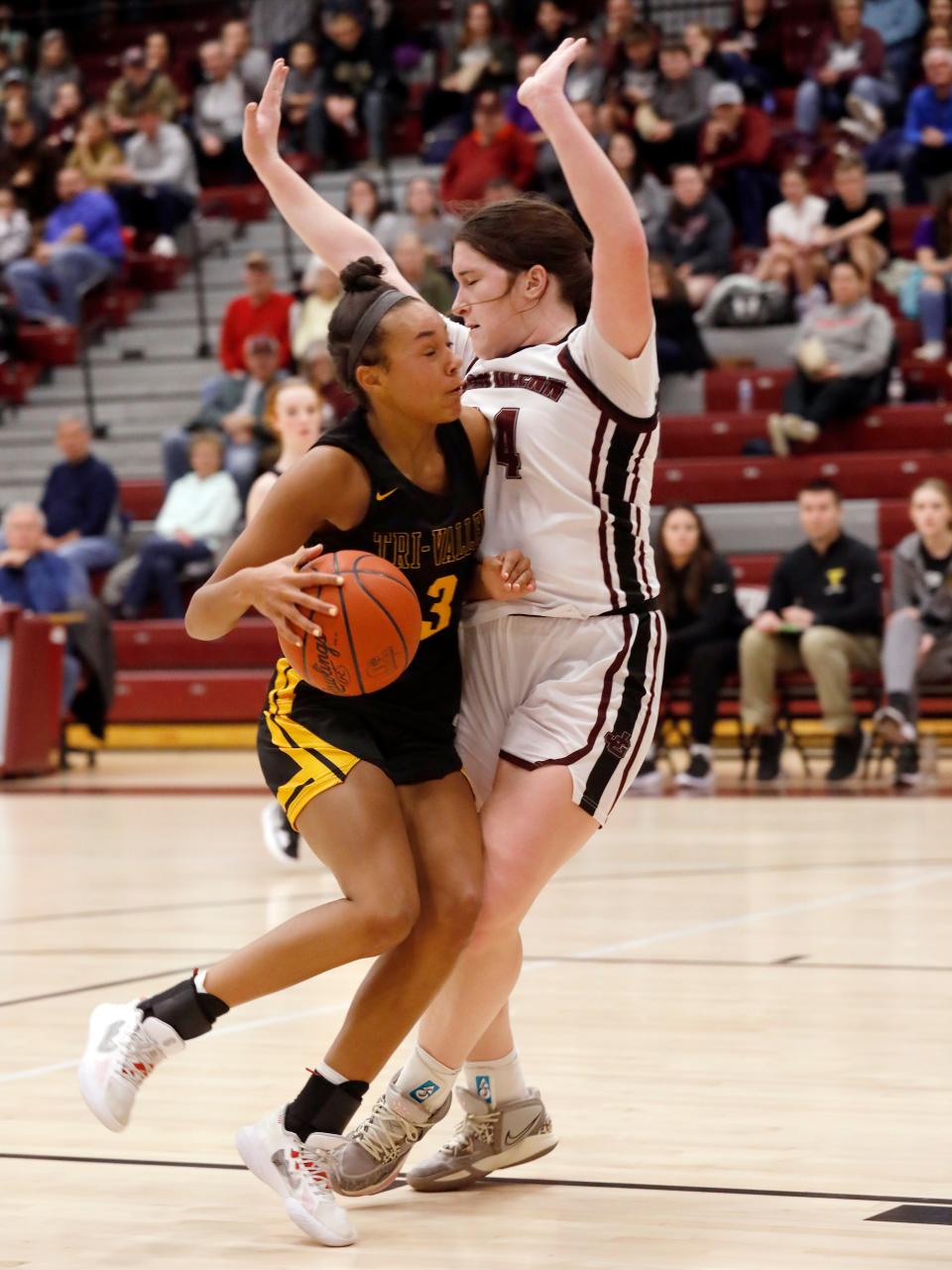 Tri-Valley's Lexi Howe drives into John Glenn's Maddie Winland on Wednesday night in New Concord.