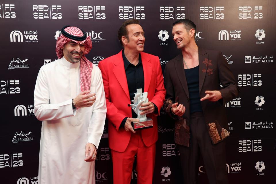 Mohammed Al Turki, Nicolas Cage and jury member Joel Kinnaman pose with the Honourary Award (Getty Images for The Red Sea Int)