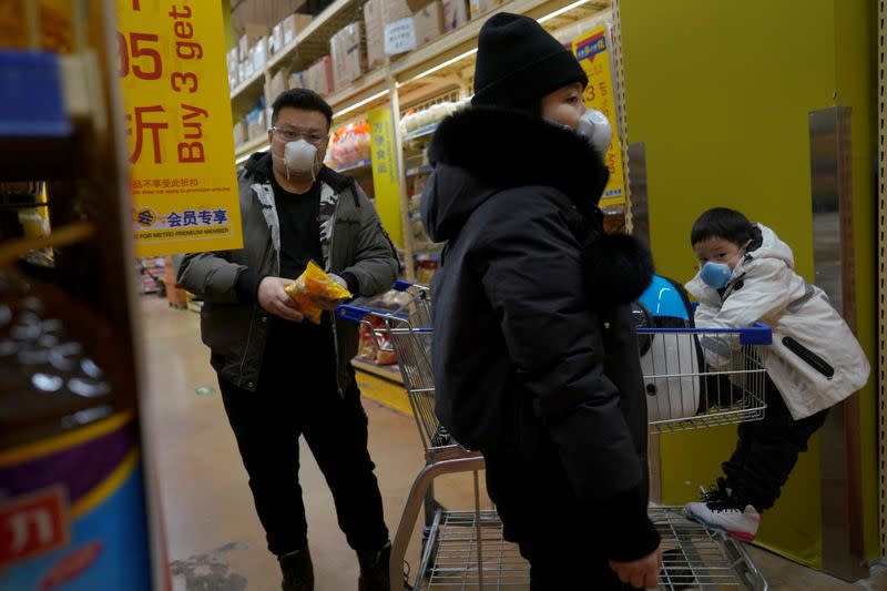 Customers wearing face masks shop inside a supermarket, as the country is hit by an outbreak of the novel coronavirus, in Beijing