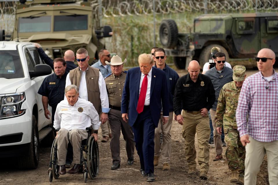 Donald Trump talks with Texas Governor Greg Abbott in Eagle Pass, Texas (AP)