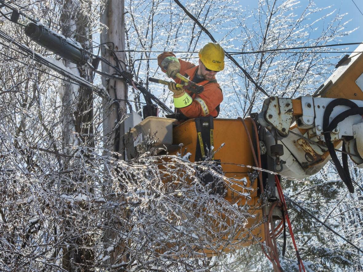Hydro Quebec workers repair power lines in Laval, Que., in April 2019 after an ice storm hit the area. Quebec's auditor general now says Hydro is failing to adequately maintain its infrastructure.  (Ryan Remiorz/The Canadian Press - image credit)