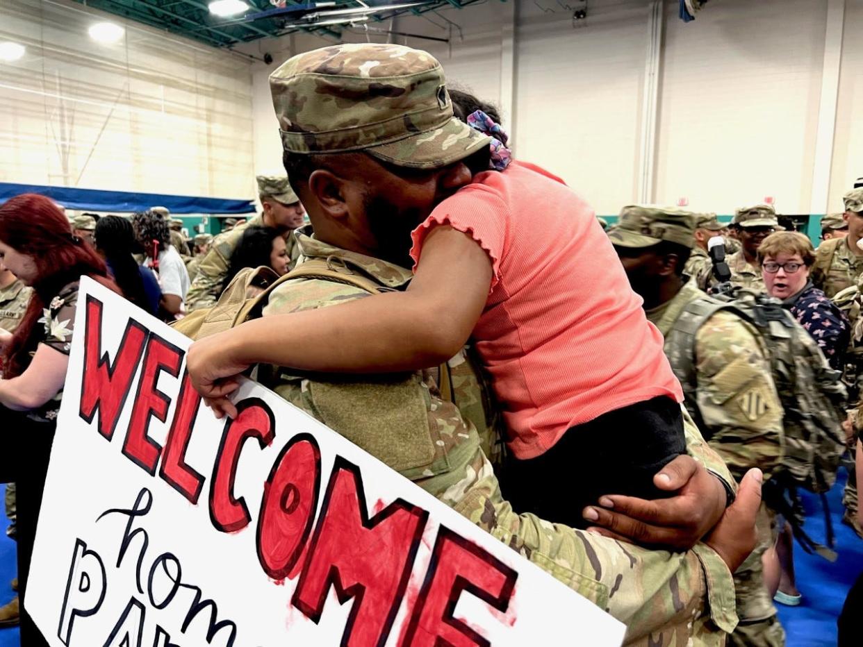 Erique Henley Sr. hugs his daughter, Erin Marshaé Henley, in Newman Gym on Fort Stewart after returning from a six month deployment in Europe.