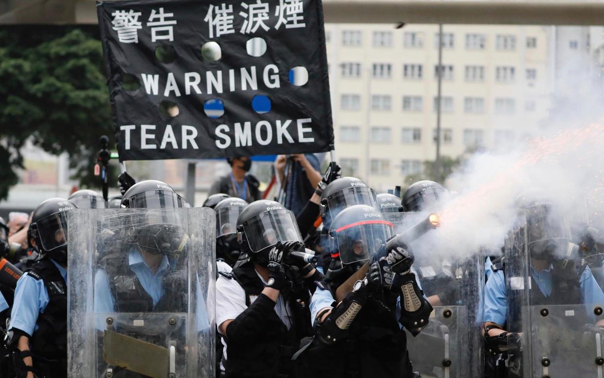 Police fire tear gas towards protesters in Hong Kong on June 12  - AP