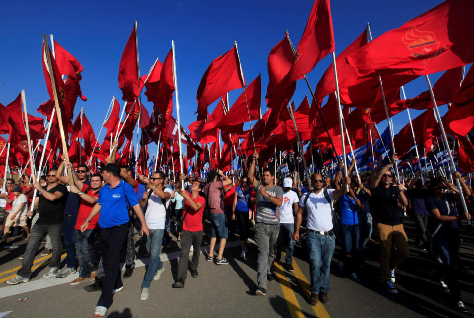 Young Communists’ League’s carry red flags