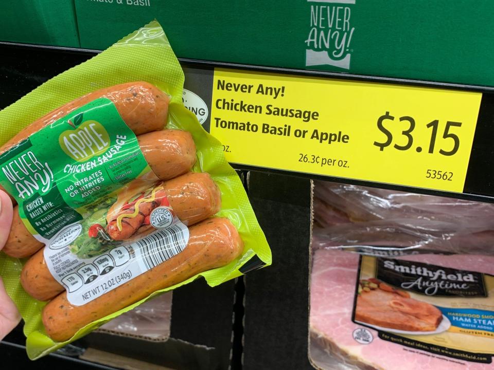 hand holding pack of never any chicken sausage at aldi