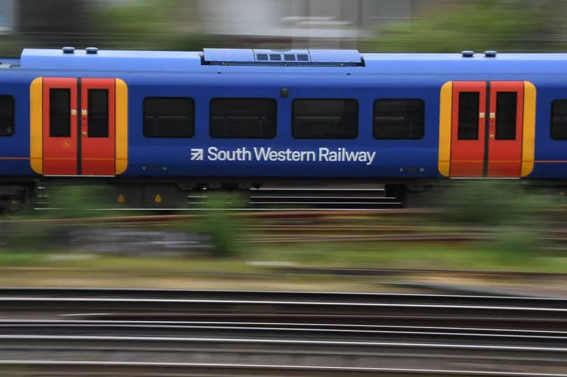 South Western train travels past Clapham Junction station