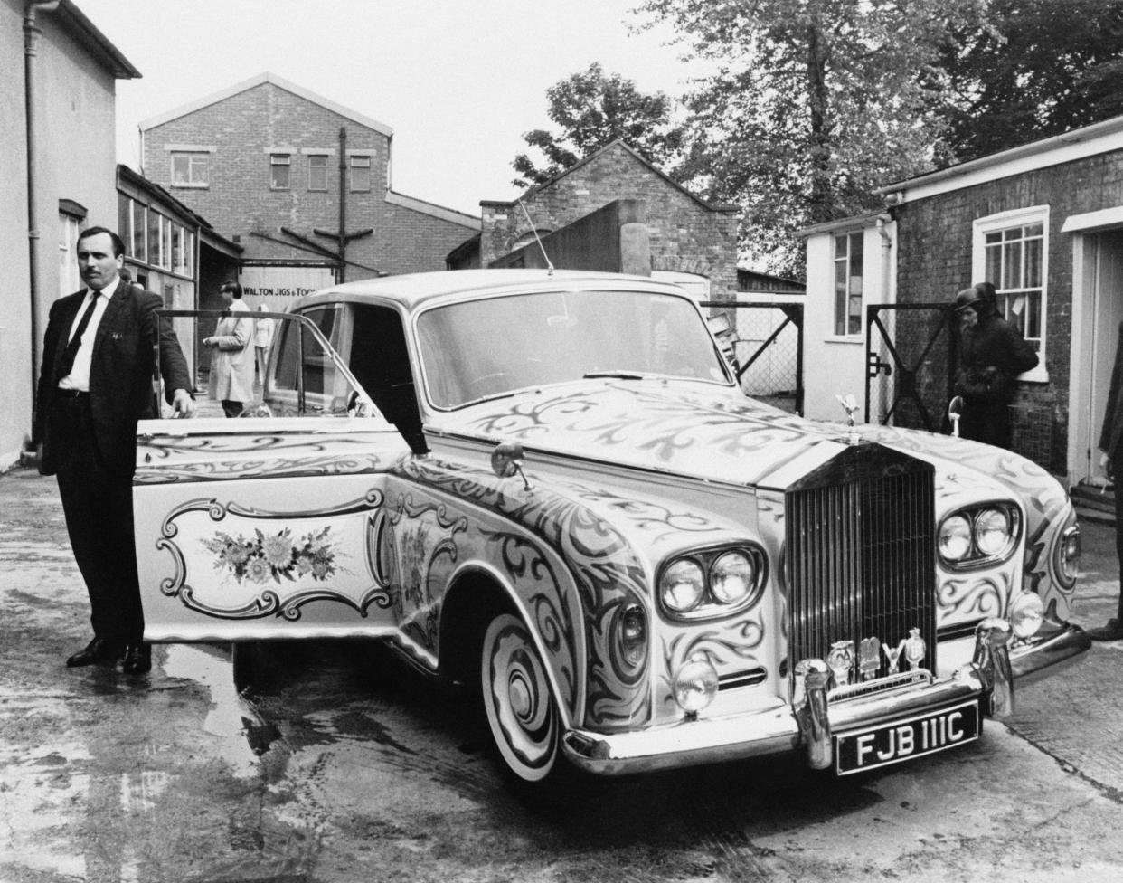Anthony stands next to John Lennon's custom-built Rolls-Royce Phantom V in 1967: Getty