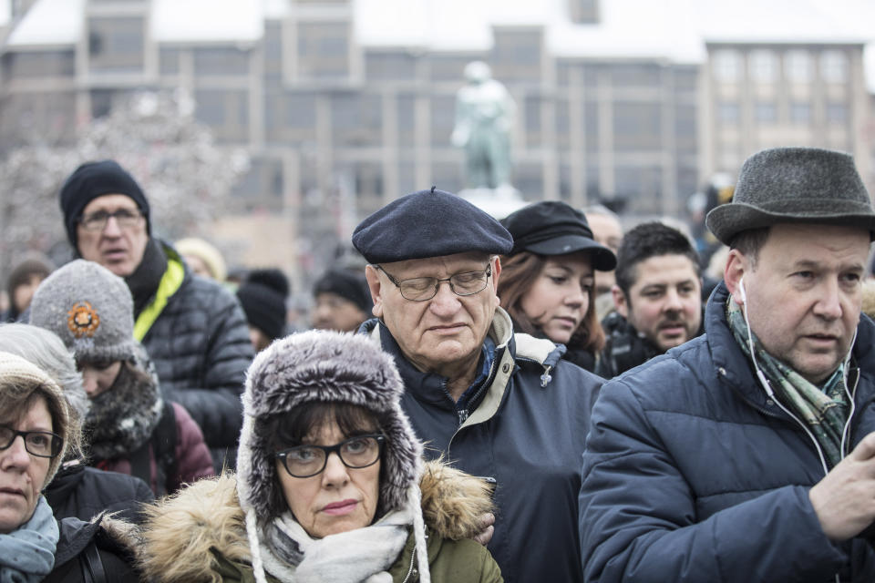 Residents react during a gathering in a central square of the eastern French city of Strasbourg, Sunday Dec.16, 2018 to pay homage to the victims of a gunman who killed four people and wounded a dozen more. The gathering was held in Kleber Square by a Christmas market and near where the gunman opened fire last Tuesday evening. (AP Photo/Jean-Francois Badias)